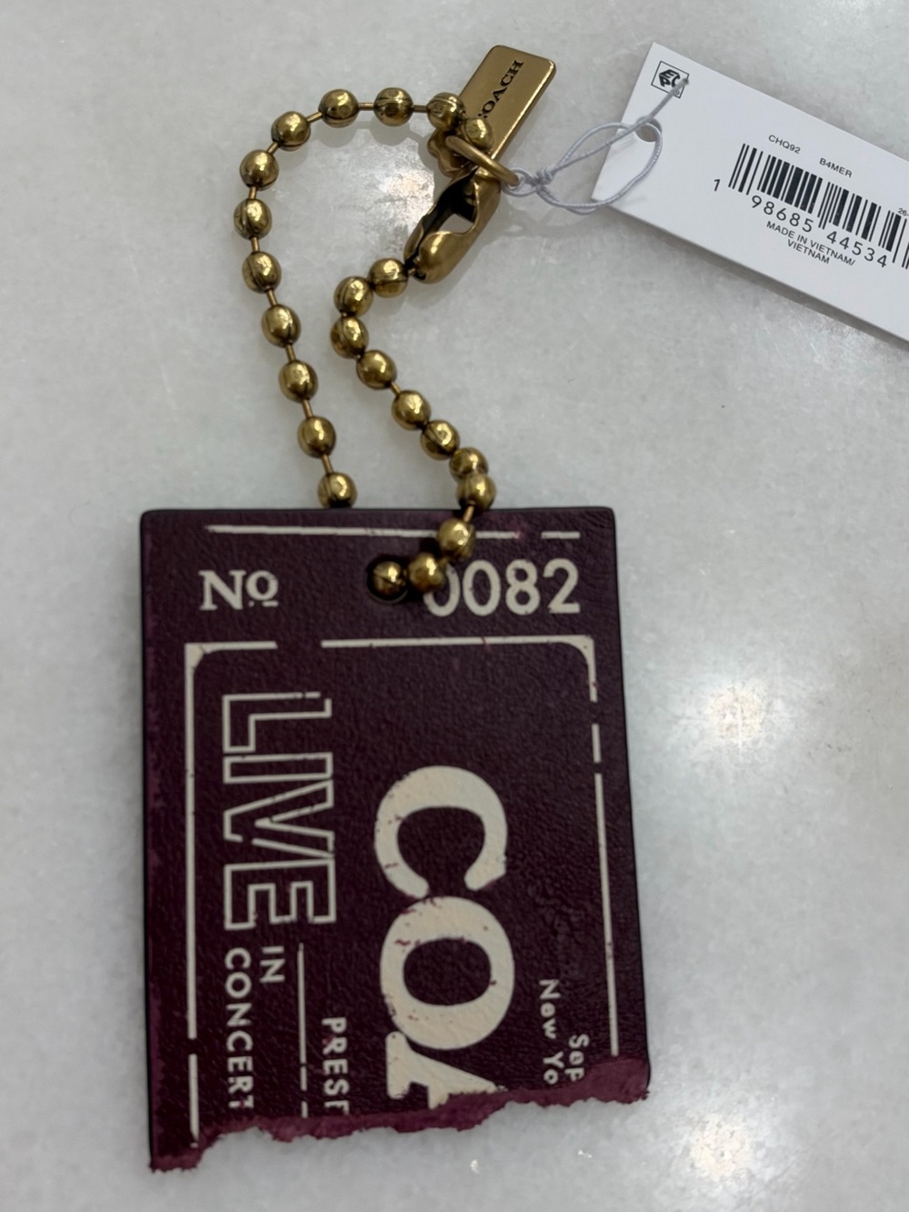Coach concert ticket bag charm maroon / merlot